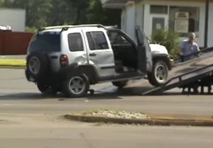Jeep Liberty being towed after an accident - Featured post for top jeep liberty years to avoid
