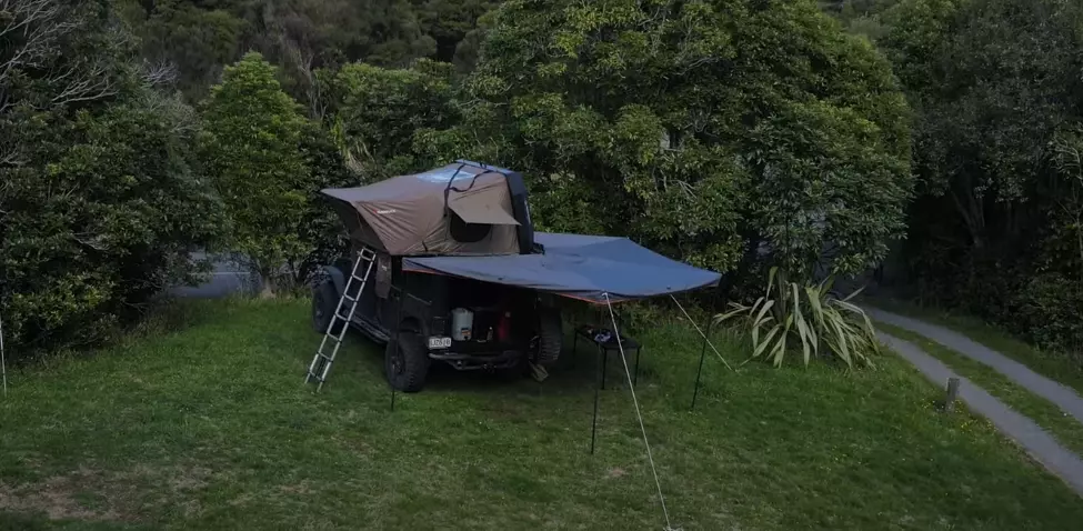 Jeep Wrangler Overlanding gear setup in the middle of the forest