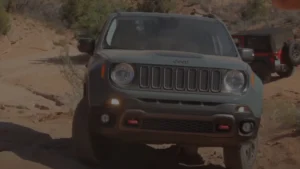 A fun and compact Jeep Renegade with a quirky design, navigating through rocky terrain.