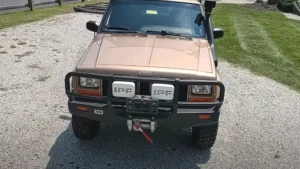 Synthetic Jeep Cherokee bumper winch installed on the front bumper of a Jeep Cherokee, featuring a durable synthetic rope and rugged construction for off-road use.