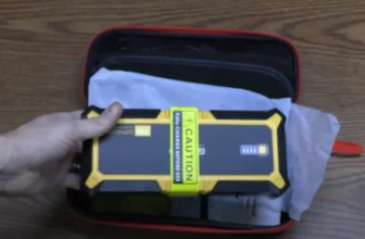Gooloo GP4000 Portable Jump Starter being unboxed, showing the device and accessories inside the box.